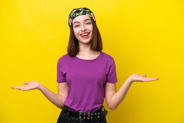 Young ukrainian woman isolated on yellow background with shocked facial expression