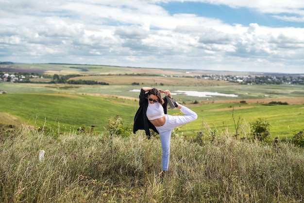 Young ukrainian woman walks on a warm summer day in the field. lifsyle