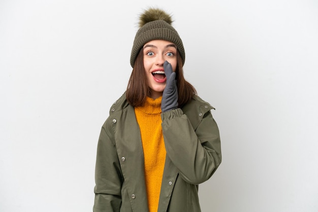 Young Ukrainian woman wearing winter jacket isolated on white background with surprise and shocked facial expression
