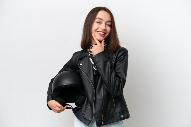 Young Ukrainian woman with a motorcycle helmet isolated on white background happy and smiling