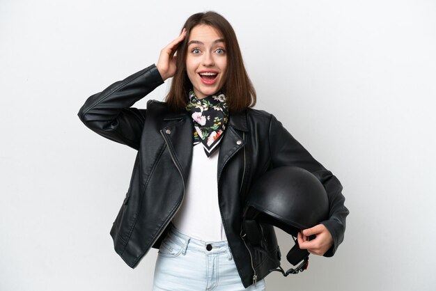 Young Ukrainian woman with a motorcycle helmet isolated on white background with surprise expression