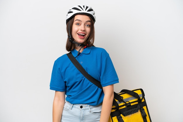 Young ukrainian woman with thermal backpack isolated on white background with surprise facial expression