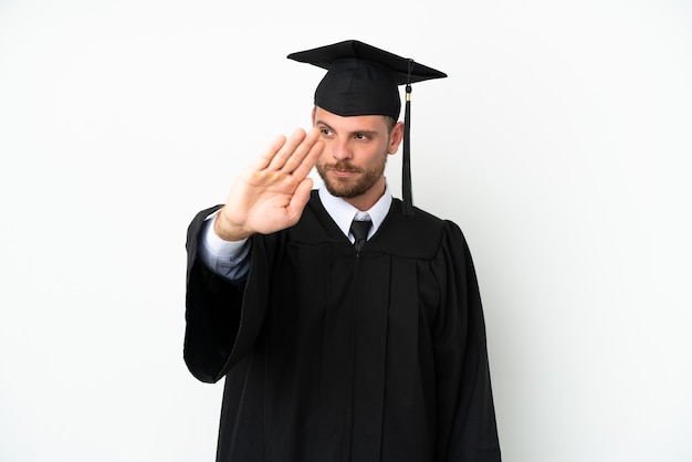 Young university Brazilian graduate isolated on white background making stop gesture and disappointed