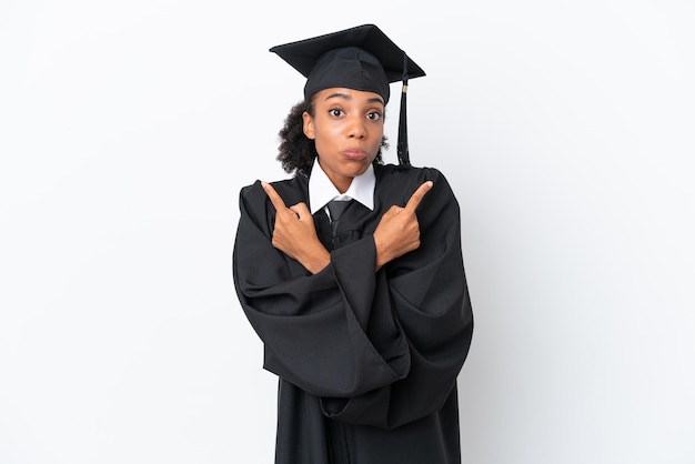 Young university graduate African American woman isolated on white background pointing to the laterals having doubts