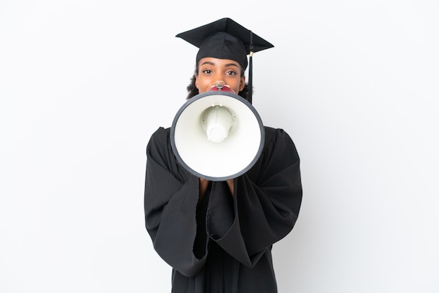 Young university graduate African American woman isolated on white background shouting through a megaphone