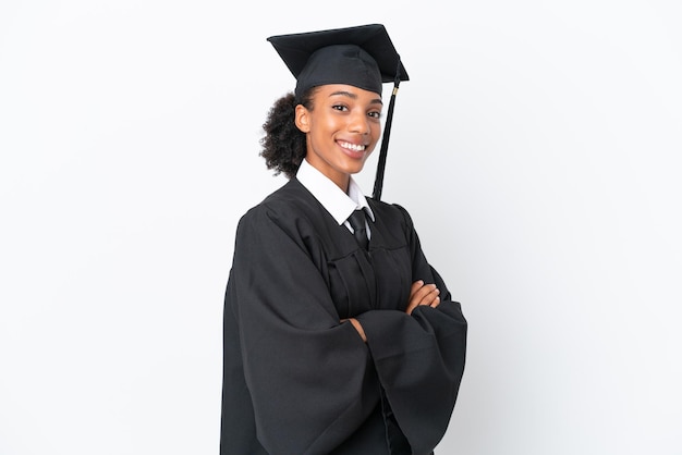 Young university graduate African American woman isolated on white background with arms crossed and looking forward