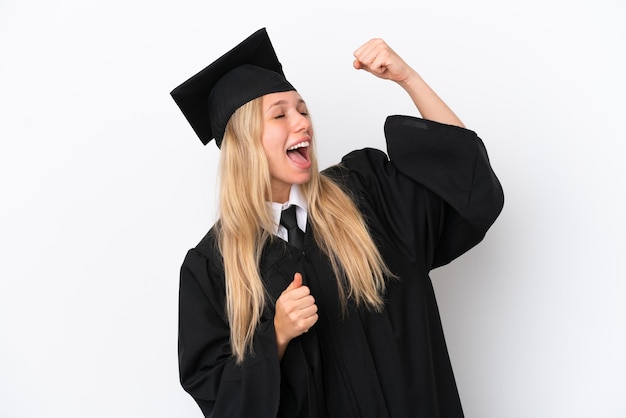 Young university graduate caucasian woman isolated on white background celebrating a victory