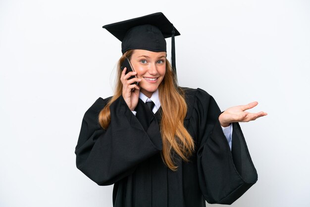 Young university graduate caucasian woman isolated on white background keeping a conversation with the mobile phone with someone