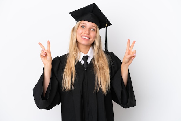 Young university graduate caucasian woman isolated on white background showing victory sign with both hands