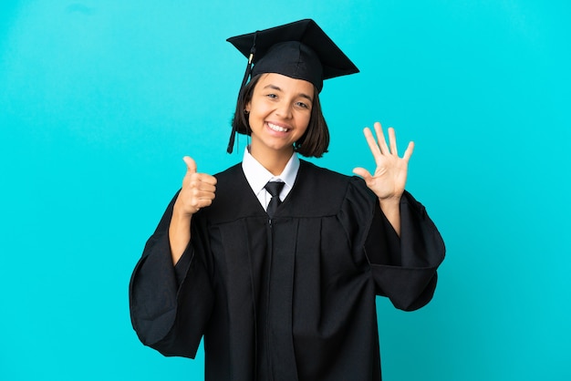 Young university graduate girl over isolated blue background counting six with fingers