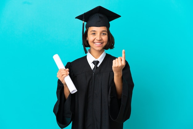 Young university graduate girl over isolated blue background doing coming gesture