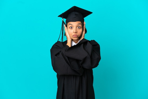 Photo young university graduate girl over isolated blue background frustrated and covering ears