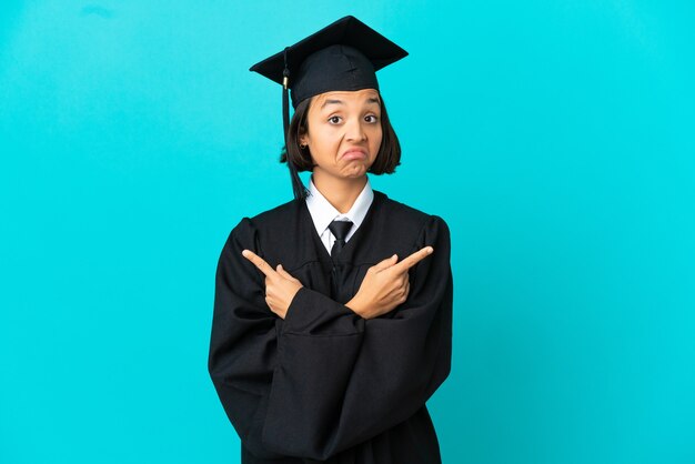 Young university graduate girl over isolated blue background pointing to the laterals having doubts