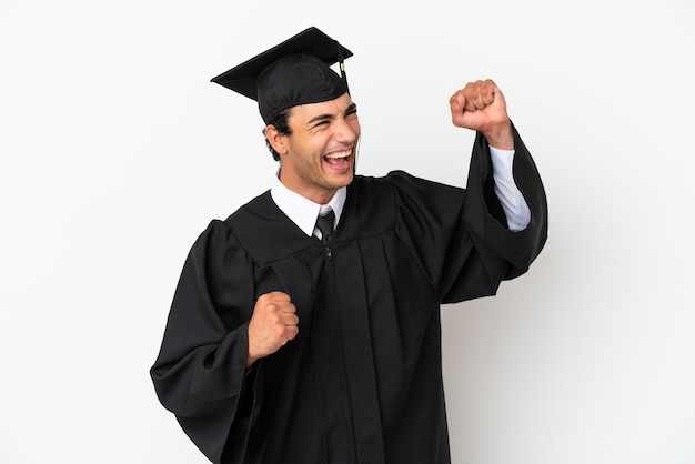 Young university graduate over isolated white background celebrating a victory