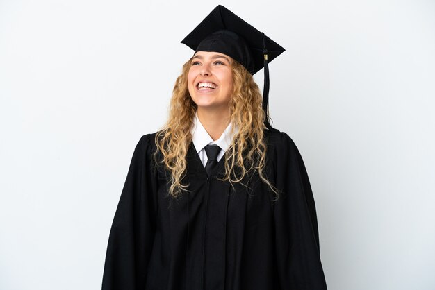 Young university graduate isolated on white background laughing