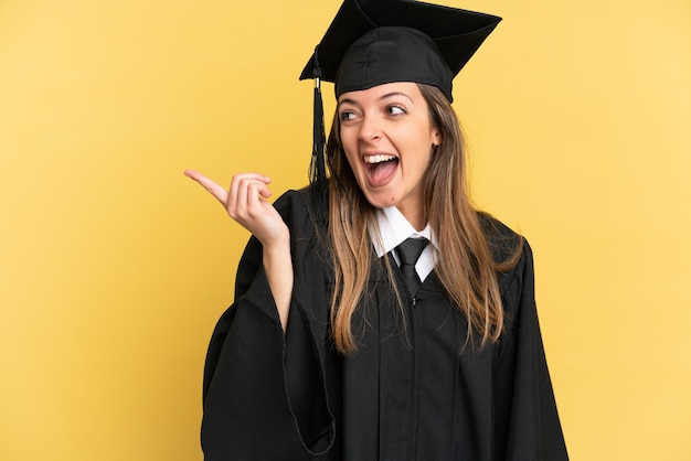 Young university graduate isolated on yellow background intending to realizes the solution while lifting a finger up