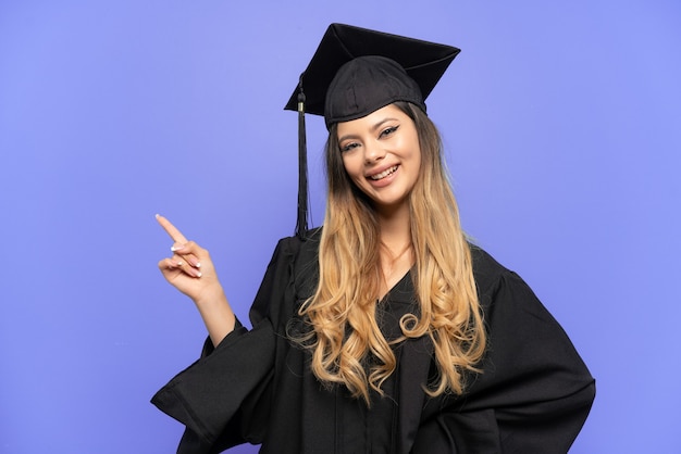 Young university graduate Russian girl isolated on white wall pointing finger to the side and presenting a product