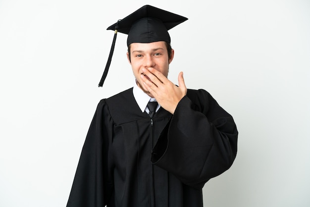 Giovane laureato russo universitario isolato su sfondo bianco felice e sorridente che copre la bocca con la mano