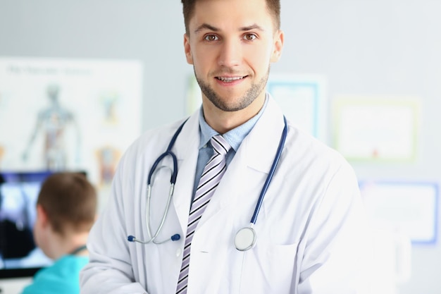 Young unshaven male doctor smiling close up