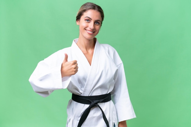 Young Uruguayan woman over isolated background with thumbs up because something good has happened