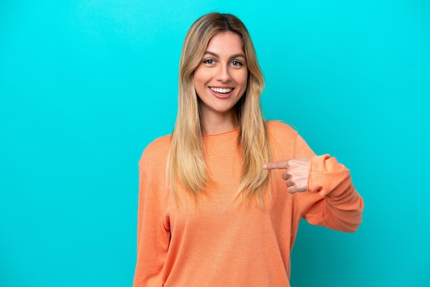 Young Uruguayan woman isolated on blue background with surprise facial expression