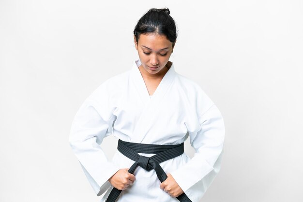 Photo young uruguayan woman over isolated white background doing karate