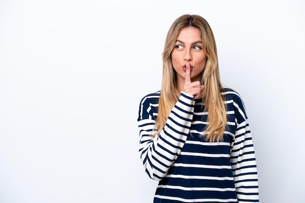 Young Uruguayan woman isolated on white background showing a sign of silence gesture putting finger in mouth