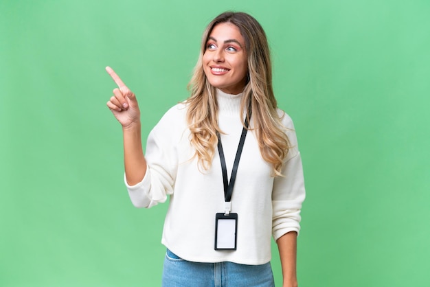 Young Uruguayan woman with ID card over isolated background intending to realizes the solution while lifting a finger up