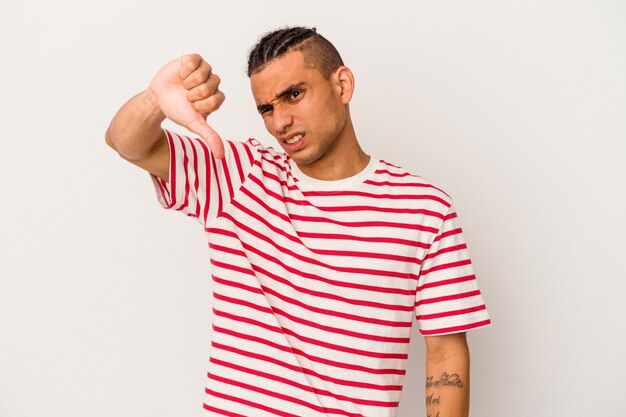 Young venezuelan man isolated on white wall showing thumb down and expressing dislike.