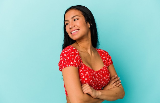 Young Venezuelan woman isolated on blue background laughing and having fun.