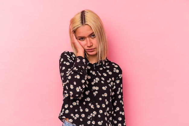 Young venezuelan woman isolated on pink background who is bored, fatigued and need a relax day.