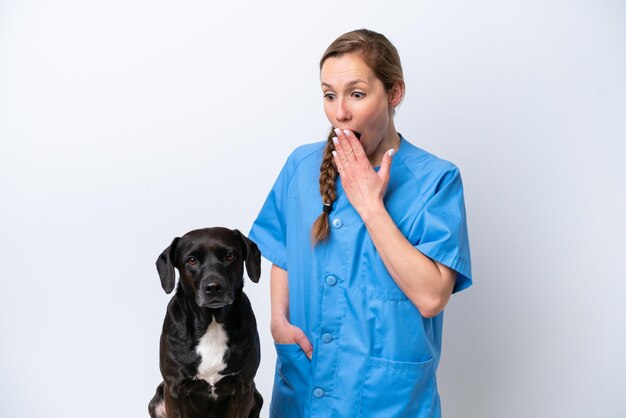 Young veterinarian woman with dog isolated on white background with surprise and shocked facial expression