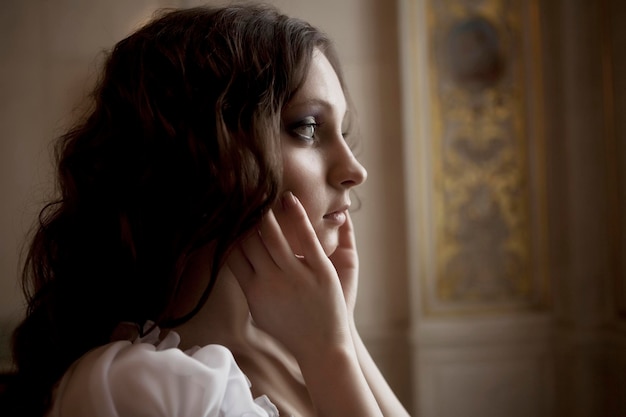 Young victorian lady in white dress