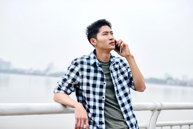 Young Vietnamese man is on the phone