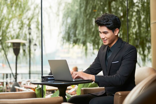 Young Vietnamese man working on laptop