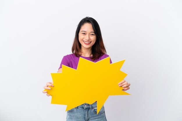 Young Vietnamese woman isolated on white background holding an empty speech bubble