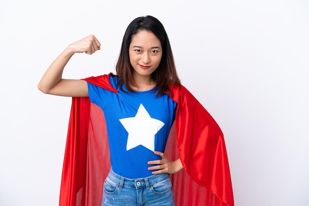 Young Vietnamese woman isolated on white background in superhero costume and doing strong gesture