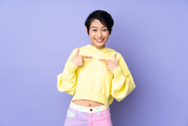 Young Vietnamese woman with short hair over isolated purple wall with surprise facial expression