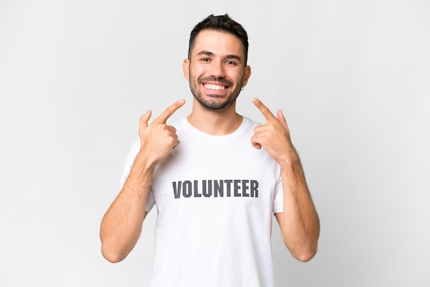 Young volunteer caucasian man over isolated white background giving a thumbs up gesture