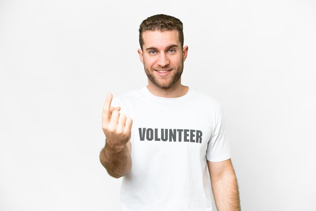 Young volunteer man over isolated white background doing coming gesture