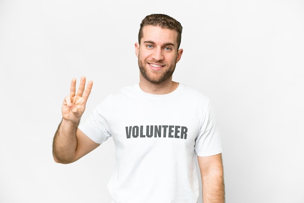 Young volunteer man over isolated white background happy and counting three with fingers