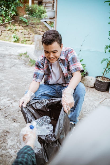 Young volunteers keep the environment clean by picking up trash