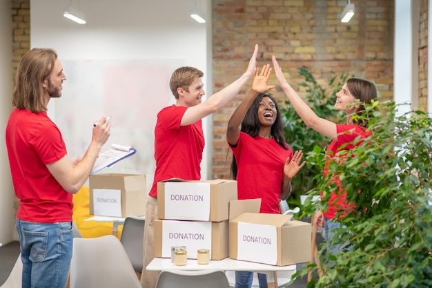 Young volunteers in red tshirts at work in a distribution point