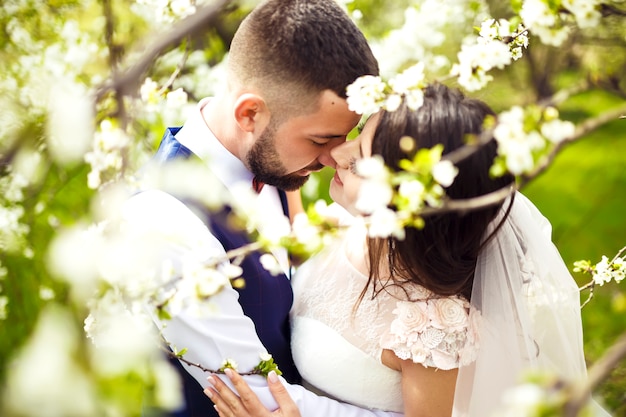 Young wedding couple enjoying romantic moments outside on a summer meadow