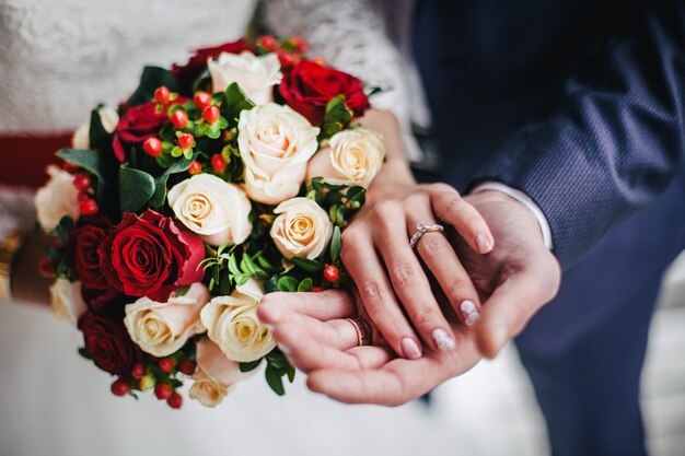 Young wedding couple holding hands