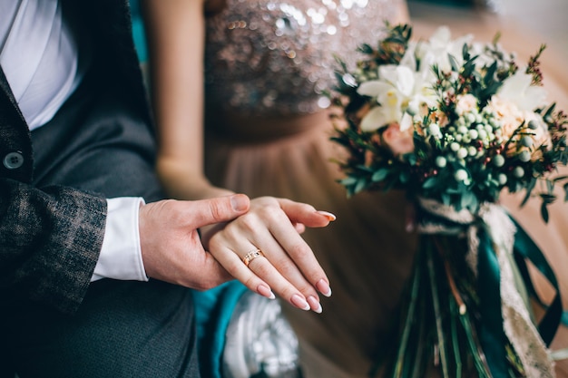 Young wedding couple holding hands