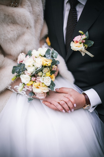 Young wedding couple holding hands