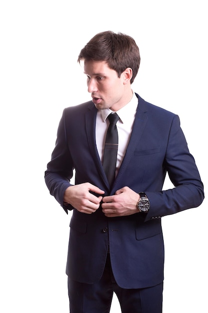 Young white handsome man in a shirt strict office suit stands isolated on a white background
