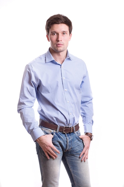 Young white handsome man in a shirt strict office suit stands isolated on a white background