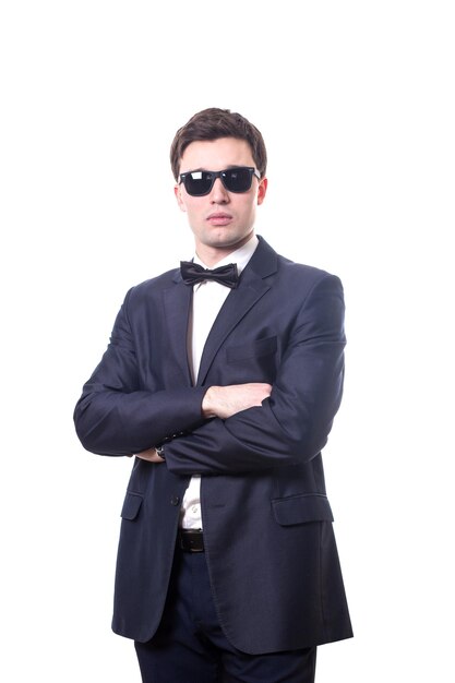 Young white handsome man in a shirt strict office suit stands isolated on a white background